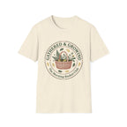 Gathered & Growing homeschool mom graphic t-shirt with a gathered-at-home inspired graphic with books, florals, and cozy family learning details