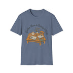 Gather Them In Beauty homeschool mom graphic t-shirt with a gathered-at-home inspired graphic with books, florals, and cozy family learning details