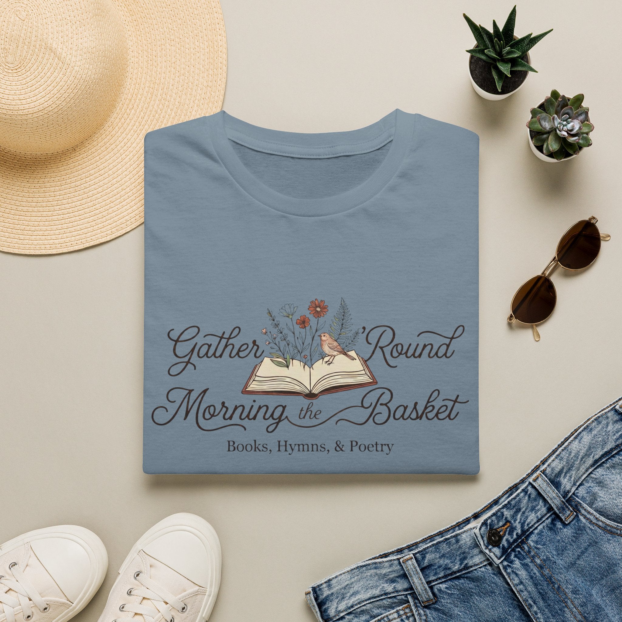 Gather Round The Morning Basket homeschool mom graphic t-shirt with a gathered-at-home inspired graphic with books, florals, and cozy family learning details