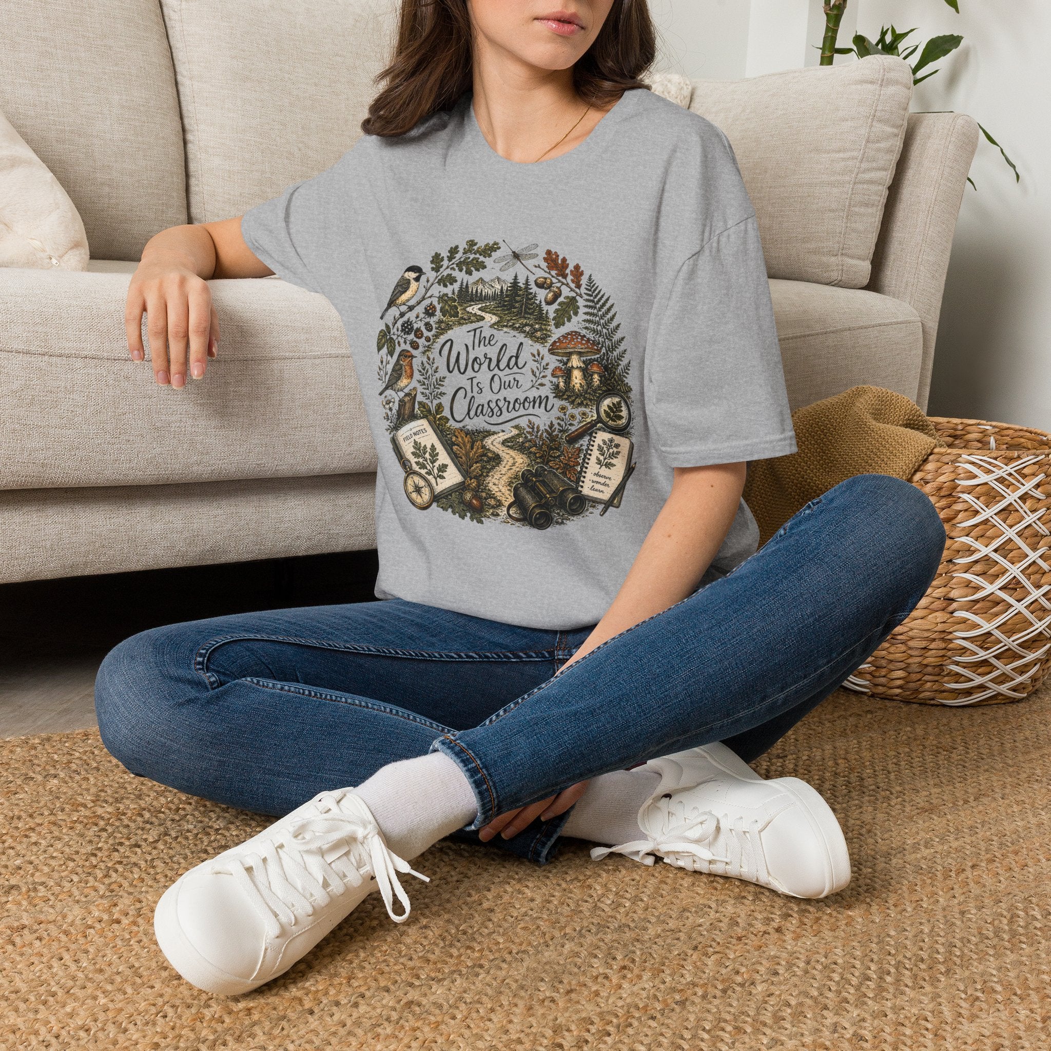 The World Is Our Classroom homeschool mom graphic t-shirt with an adventurous homeschool graphic with nature, books, and outdoor learning energy