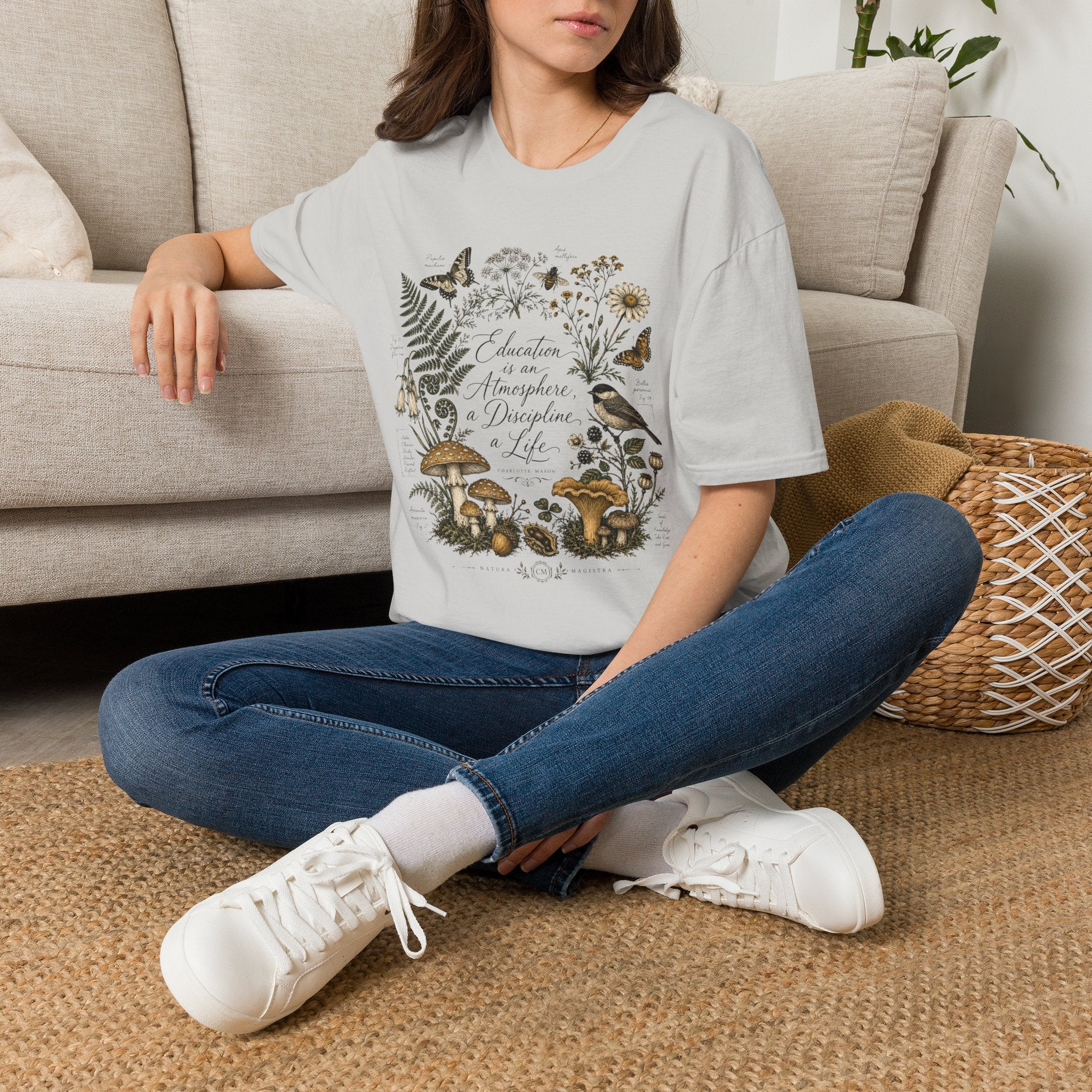 Education Is An Atmosphere homeschool mom graphic t-shirt with a Charlotte Mason-inspired design with books, nature details, and vintage homeschool charm