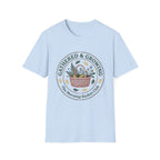 Gathered & Growing homeschool mom graphic t-shirt with a gathered-at-home inspired graphic with books, florals, and cozy family learning details