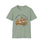 Gather Them In Beauty homeschool mom graphic t-shirt with a gathered-at-home inspired graphic with books, florals, and cozy family learning details