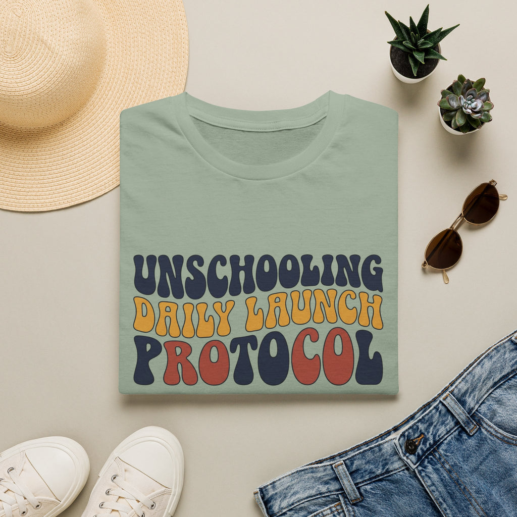 Unschooling Protocol homeschool mom graphic t-shirt with an adventurous homeschool graphic with nature, books, and outdoor learning energy