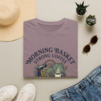 Morning Basket Strong Coffee homeschool mom graphic t-shirt with a cozy morning basket-inspired design with books, gentle details, and home learning charm