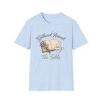 Gathered Around The Table homeschool mom graphic t-shirt with a gathered-at-home inspired graphic with books, florals, and cozy family learning details