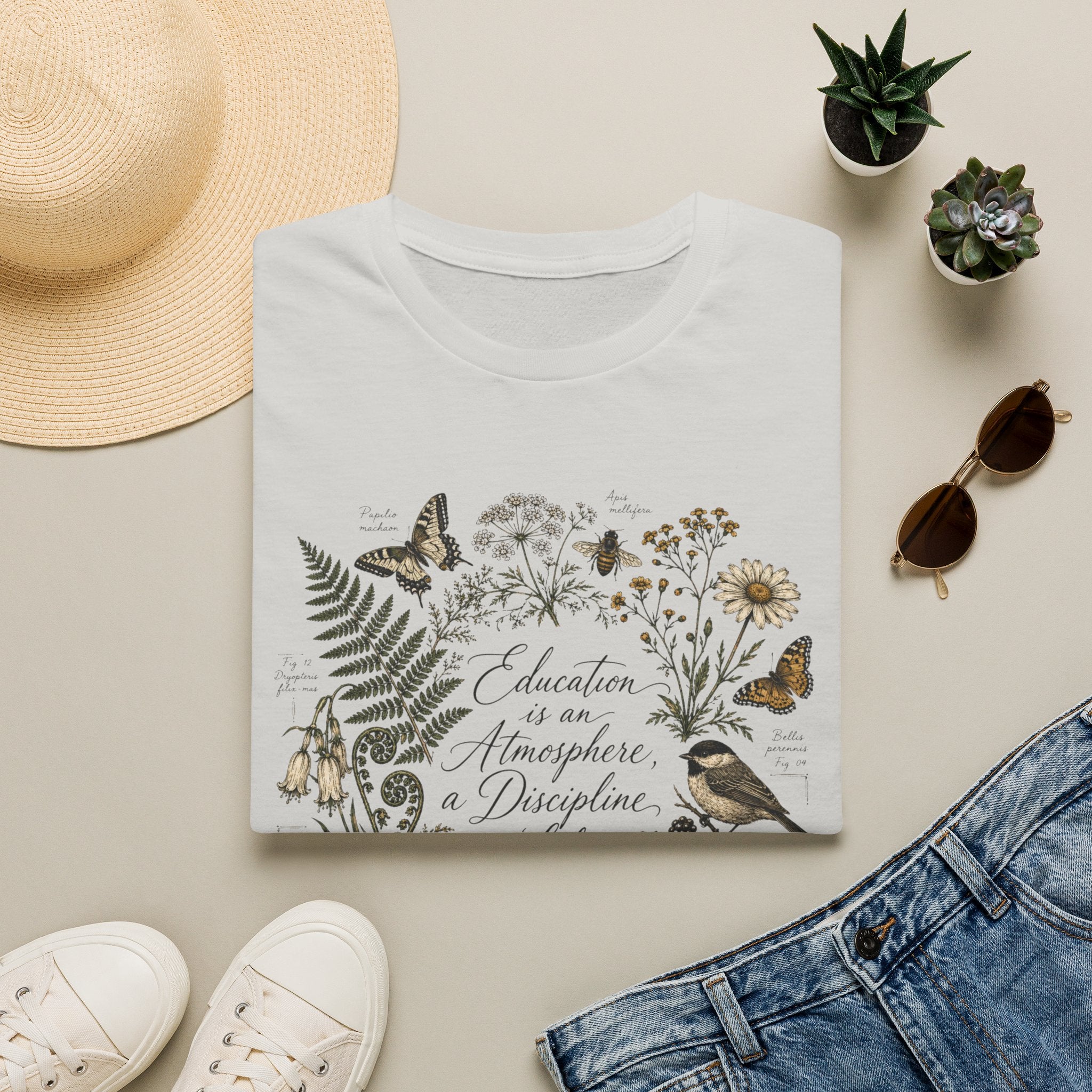 Education Is An Atmosphere homeschool mom graphic t-shirt with a Charlotte Mason-inspired design with books, nature details, and vintage homeschool charm