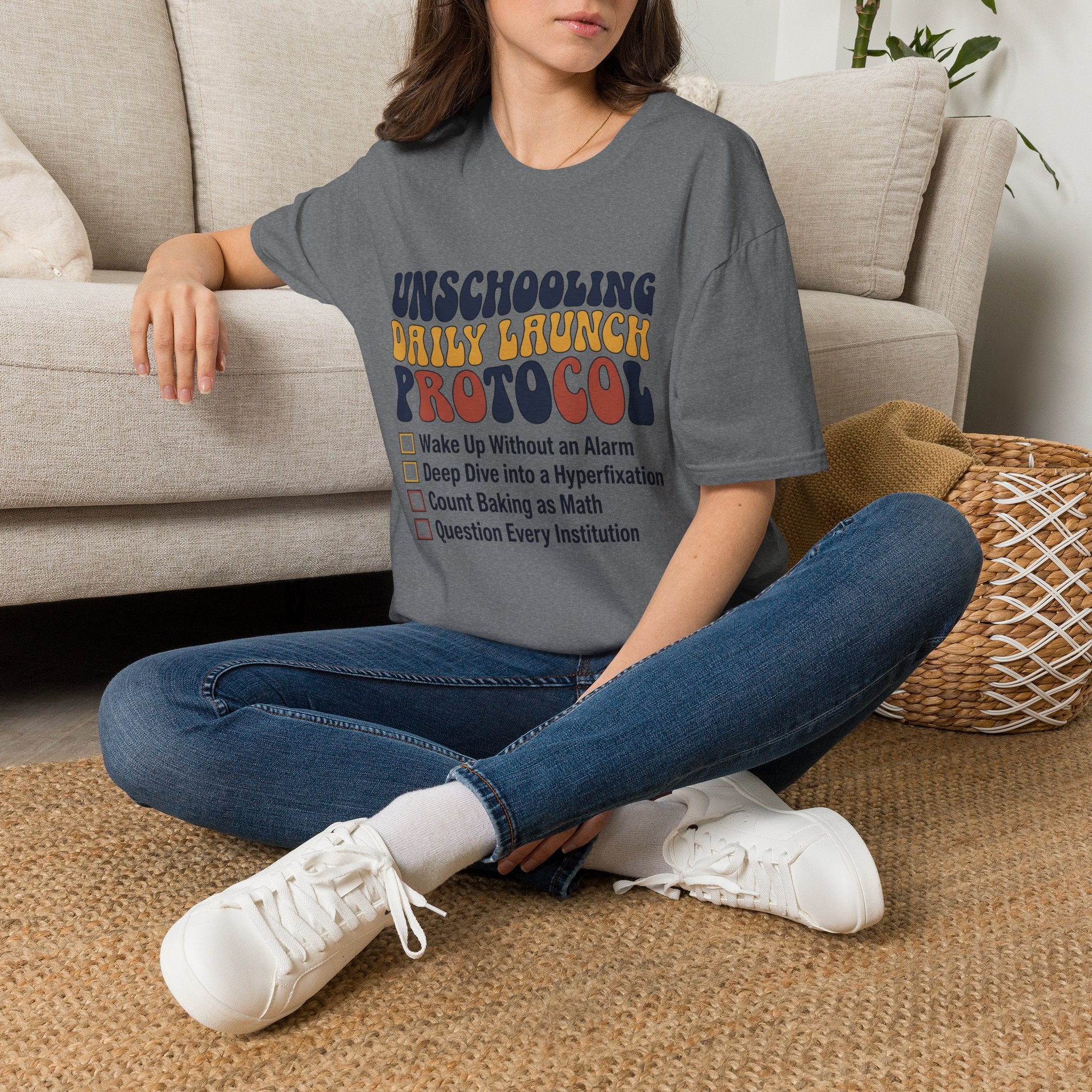 Unschooling Protocol homeschool mom graphic t-shirt with an adventurous homeschool graphic with nature, books, and outdoor learning energy