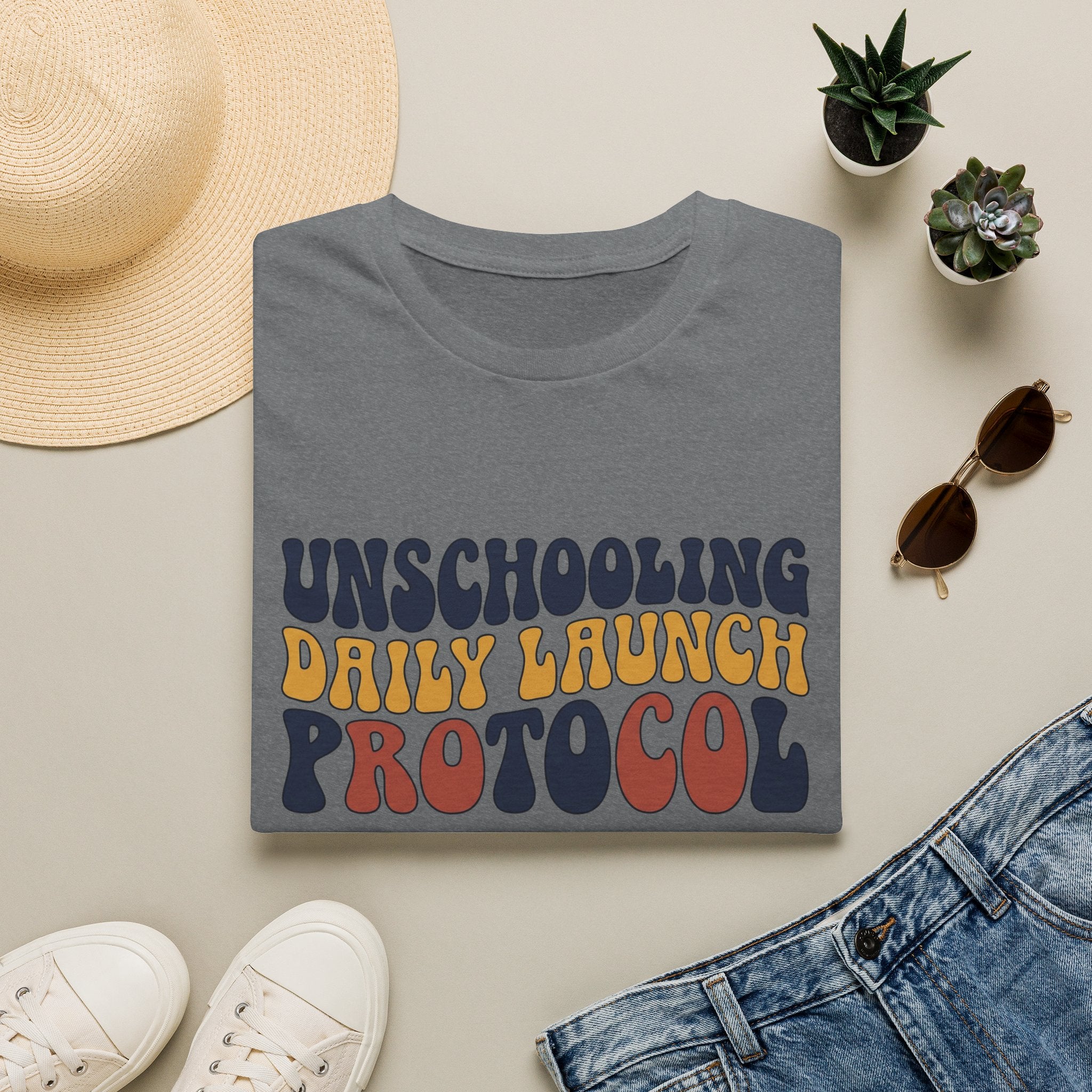 Unschooling Protocol homeschool mom graphic t-shirt with an adventurous homeschool graphic with nature, books, and outdoor learning energy