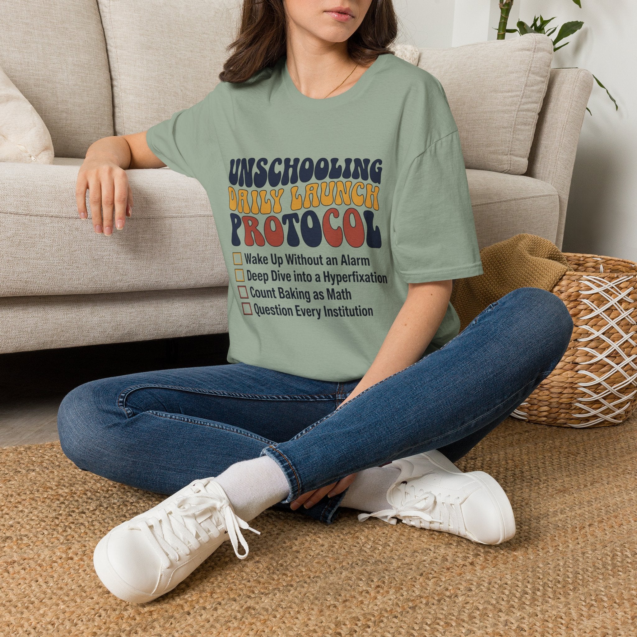 Unschooling Protocol homeschool mom graphic t-shirt with an adventurous homeschool graphic with nature, books, and outdoor learning energy