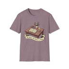 The Work At Home Is Holy homeschool mom graphic t-shirt with a gathered-at-home inspired graphic with books, florals, and cozy family learning details