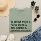 Scouting Trails Check List homeschool mom graphic t-shirt with a playful checklist-style homeschool graphic with bookish and nature-inspired details