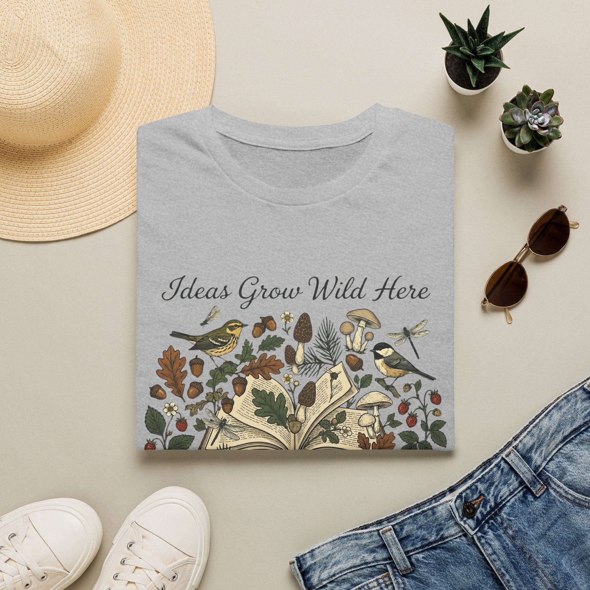 Ideas Grow Wild Here homeschool mom graphic t-shirt with an adventurous homeschool graphic with nature, books, and outdoor learning energy
