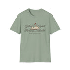 Gather Round The Morning Basket homeschool mom graphic t-shirt with a gathered-at-home inspired graphic with books, florals, and cozy family learning details