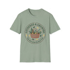 Gathered & Growing homeschool mom graphic t-shirt with a gathered-at-home inspired graphic with books, florals, and cozy family learning details