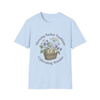 Morning Basket Tradition homeschool mom graphic t-shirt with a cozy morning basket-inspired design with books, gentle details, and home learning charm