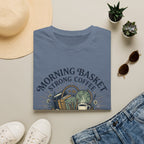Morning Basket Strong Coffee homeschool mom graphic t-shirt with a cozy morning basket-inspired design with books, gentle details, and home learning charm
