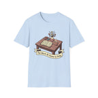 The Work At Home Is Holy homeschool mom graphic t-shirt with a gathered-at-home inspired graphic with books, florals, and cozy family learning details