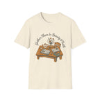 Gather Them In Beauty homeschool mom graphic t-shirt with a gathered-at-home inspired graphic with books, florals, and cozy family learning details