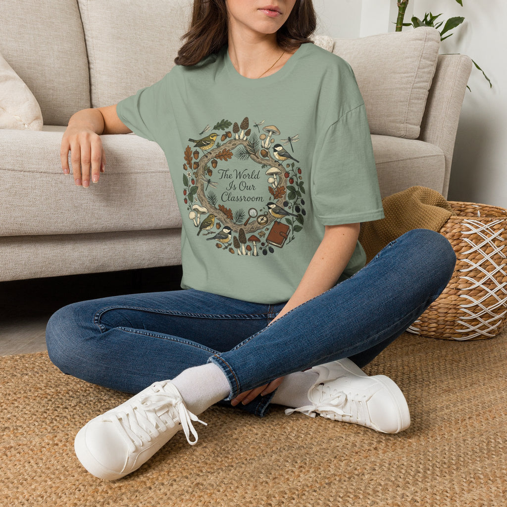 The World Is Our Classroom homeschool mom graphic t-shirt with an adventurous homeschool graphic with nature, books, and outdoor learning energy