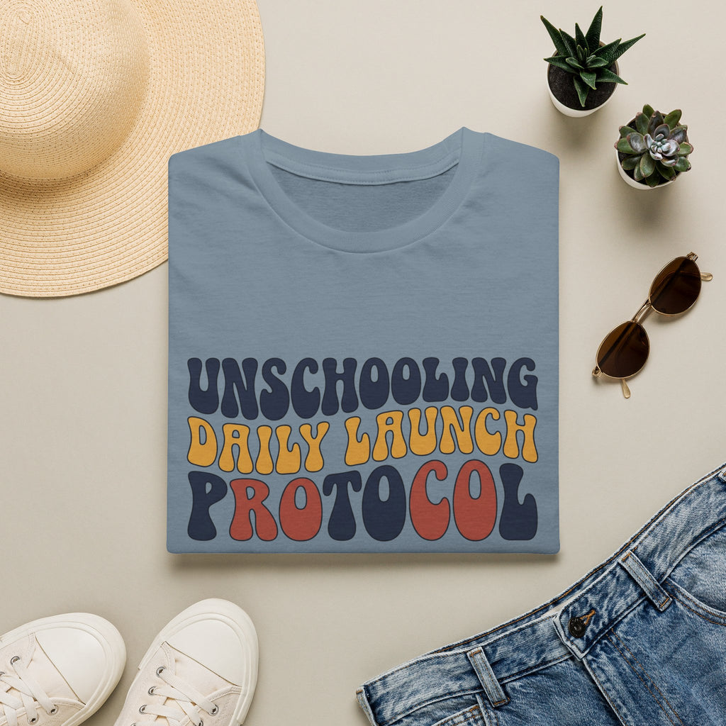 Unschooling Protocol homeschool mom graphic t-shirt with an adventurous homeschool graphic with nature, books, and outdoor learning energy